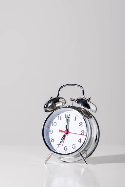 Close-up view of shiny alarm clock on grey — Stock Photo