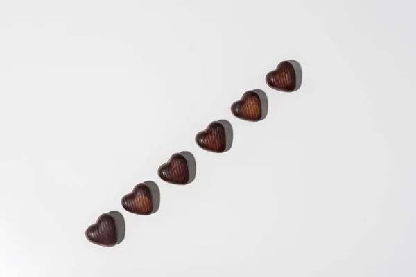 Top view of delicious chocolate heart shaped candies isolated on grey — Stock Photo