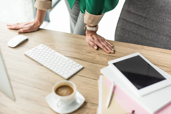 Cropped shot of businesswoman using desktop computer and digital tablet at workplace — Stock Photo