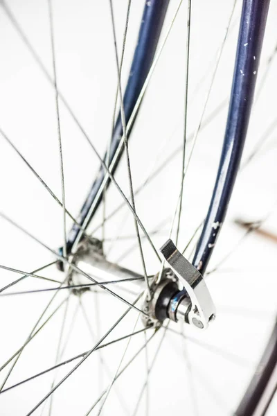 Close up of bicycle wheel with spokes and fork isolated on white — Stock Photo