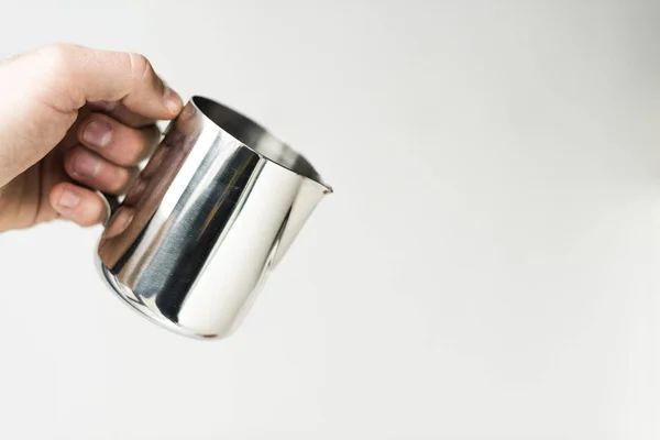 Cropped image of man holding milk pitcher isolated on white — Stock Photo