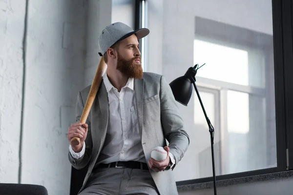 Businessman holding baseball ball and baseball bat — Stock Photo