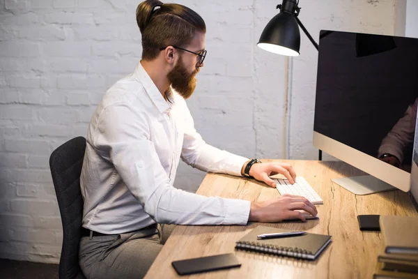 Businessman typing something on keyboard in office — Stock Photo