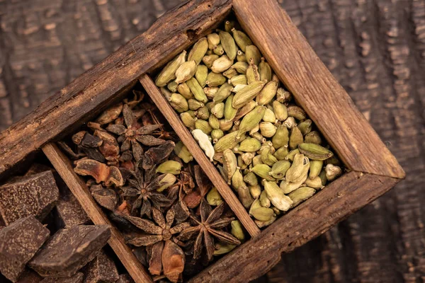 Top view of wooden box with various spices on table — Stock Photo