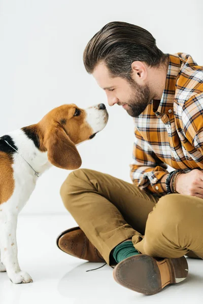 Side view of dog sniffing man nose — Stock Photo