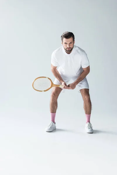 Handsome tennis player with tennis racket on grey — Stock Photo