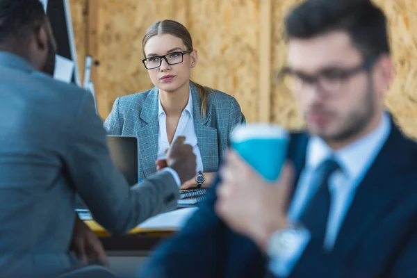 Multicultural businesswoman and businessman talking in office — Stock Photo