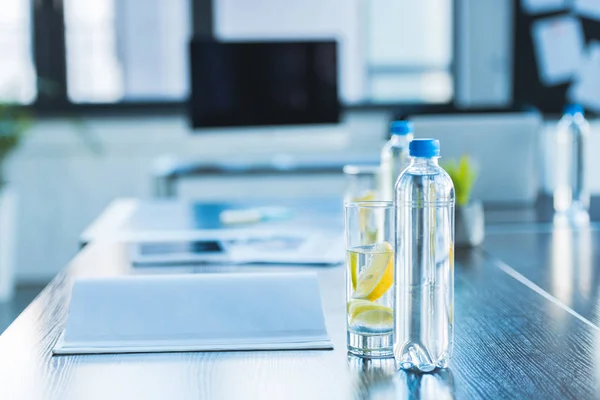 Bottles and glasses with antioxidant drink for business meeting in office — Stock Photo