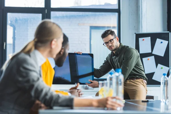 Multiethnic businesspeople looking at computer screen during meeting in office — Stock Photo