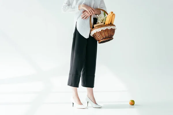 Vista de close-up da mulher na moda que transporta a cesta com pão e flores — Fotografia de Stock