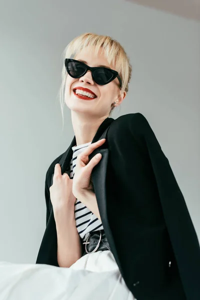 Stylish pretty woman in sunglasses with red lips isolated on grey — Stock Photo