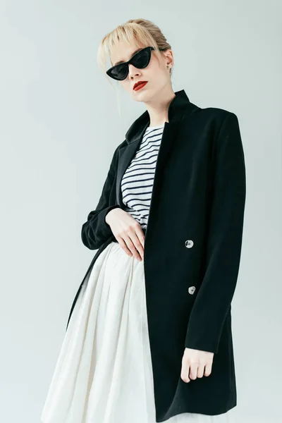Fashionable blonde girl wearing black jacket and sunglasses isolated on grey — Stock Photo