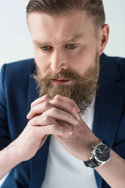 Uomo con baffi vintage e barba appoggiata su mani serrate isolate su sfondo chiaro — Foto stock