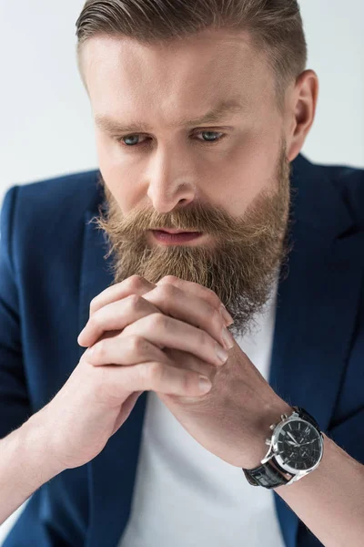 Man with vintage mustache and beard leaning on clenched hands isolated on light background — Stock Photo