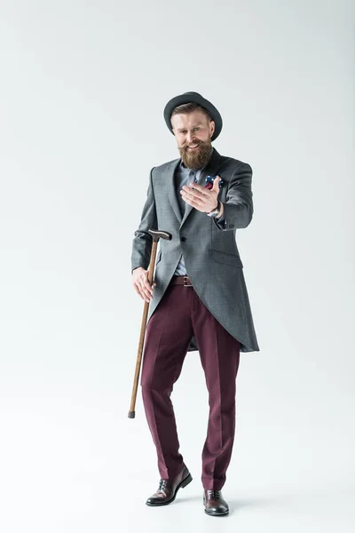 Man with vintage mustache and beard holding cane and reaching with hand — Stock Photo