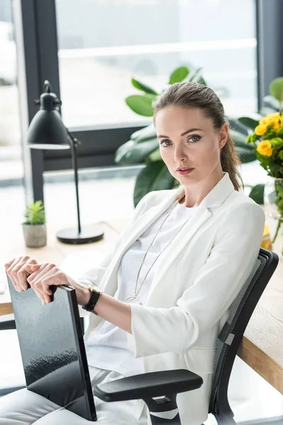 Portrait of beautiful businesswoman with book at workplace in office — Stock Photo