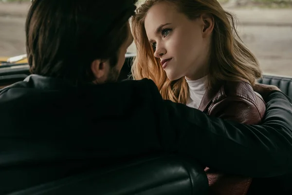 Back view of sensual young couple in love sitting together in car — Stock Photo