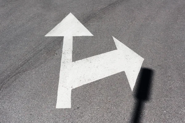 Traffic arrows painted white on asphalt road — Stock Photo