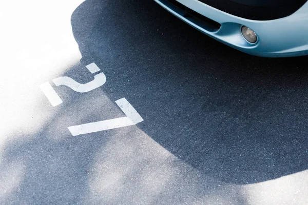 Close-up view of car on street parking lot at number 27 — Stock Photo