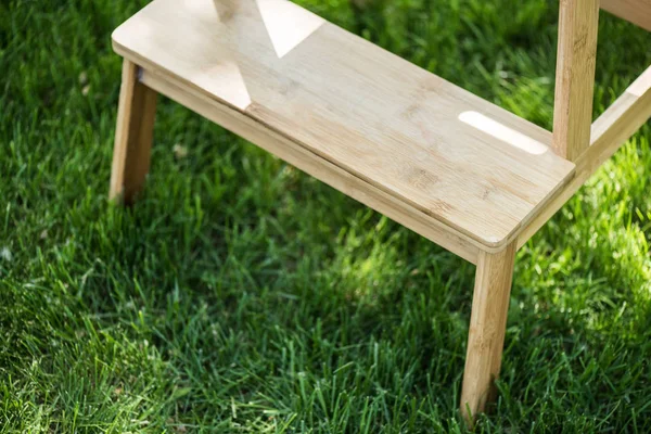 Close up view of wooden stairs standing on green grass — Stock Photo