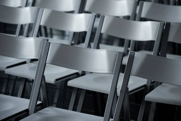 Close up view of arranged empty modern chairs — Stock Photo