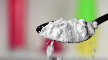 Ekstra sınıf demir kaşık gelen düşen un. Arka plan bulanık. Ağır çekim