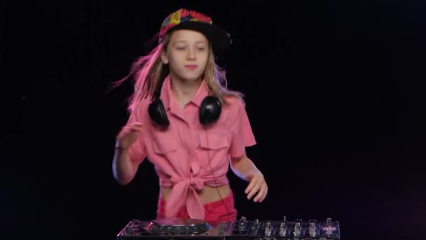 Teenage girl plays music and dances at dj table. Studio — Stock Video