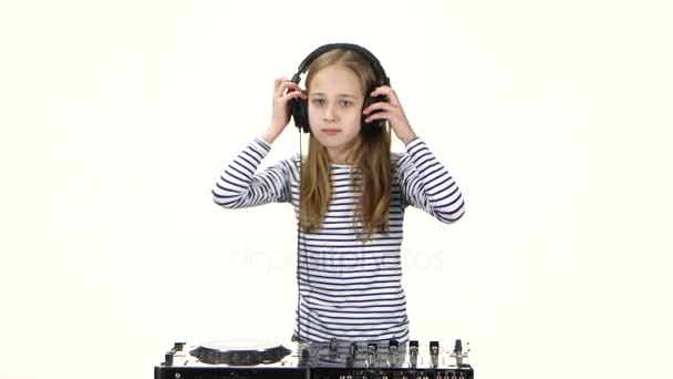 Teenager girl dj playing on vinyl wears headphones. White background — Stock Video