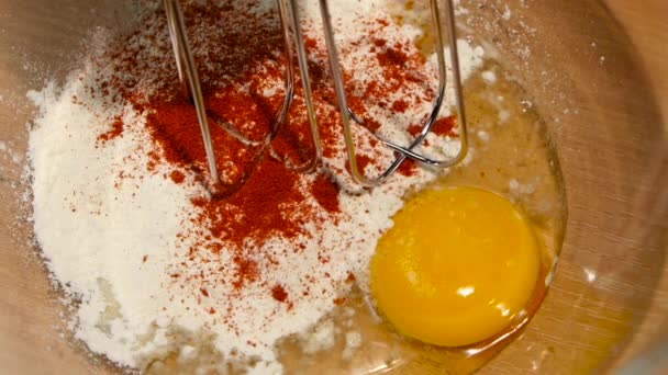 Electric mixer whisk egg, spices and flour in slow motion — Stock Video