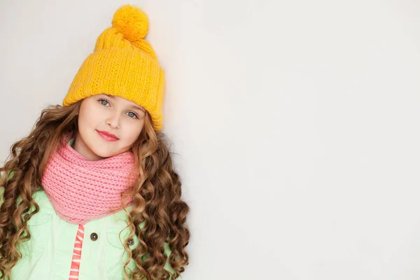 Cute little lady wearing yellow woolen cap and warm scarf — Stock Photo, Image