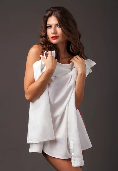 Vacker dam gömmer sig bakom vit skjorta — Stockfoto