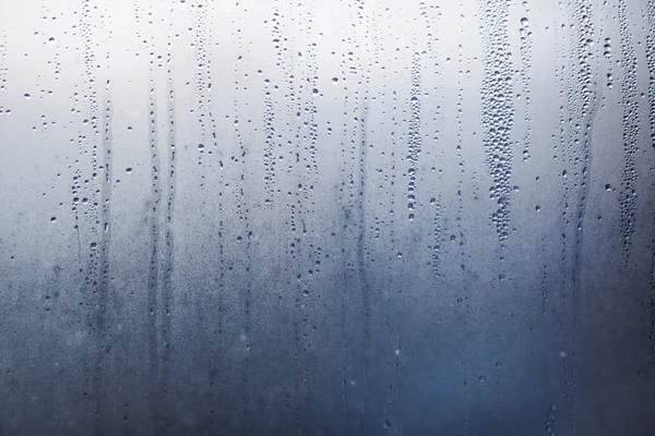 Flowing down water drops on window glass — Stock Photo, Image