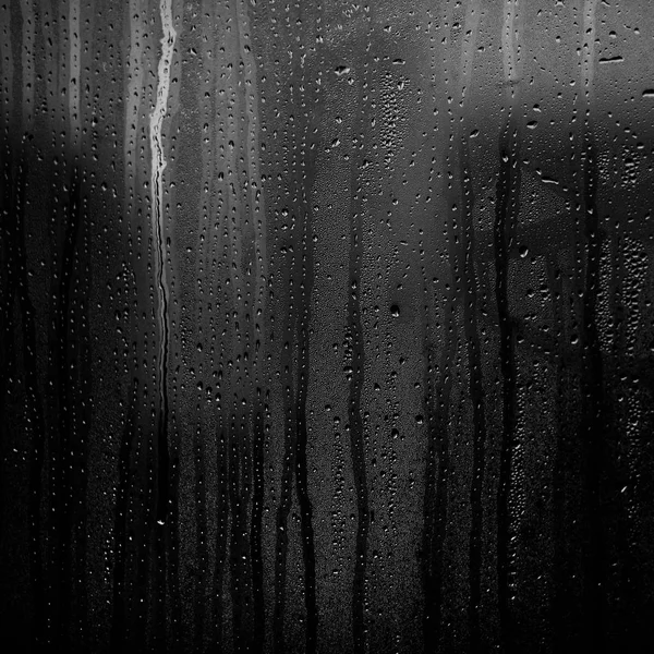 Flowing down water drops on window glass — Stock Photo, Image