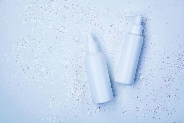 Two bottles of cosmetic products surrounded by sparkles — Stock Photo, Image