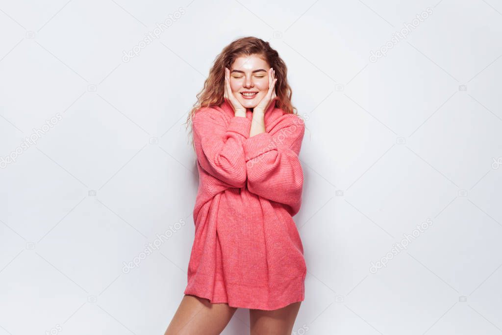 Beautiful woman in long pink sweater 
