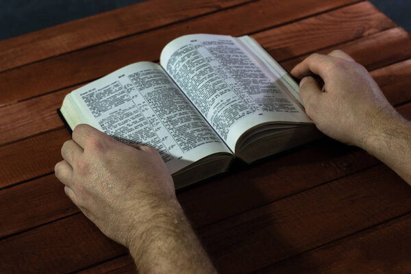 Bible on a red wooden table. Beautiful background.Religion concept