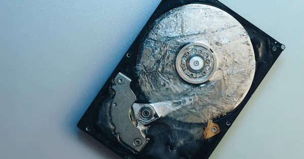 Close up beautiful open detail frozen hard disk on a white table background. Concept protection information or save usser data. Top view.