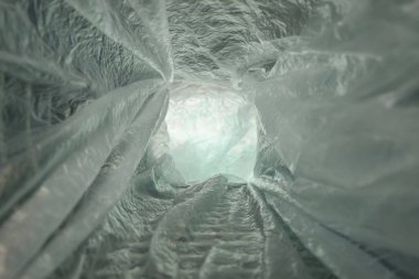 Beautiful abstract Tunnel background of plastic cellophane bag. No plastic bag concept saves the world, protects the earth. clipart