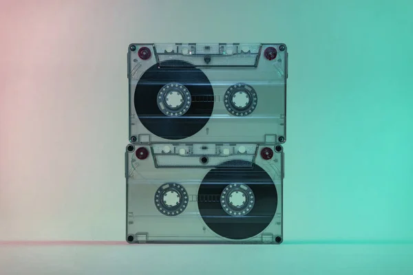 Beautiful Audio cassette tape in neon  light.Minimalism retro style concept. 80s. Background pattern for design.