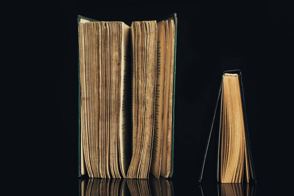 Beautiful ancient books. Pattern background for design. The book on a black glass table background.