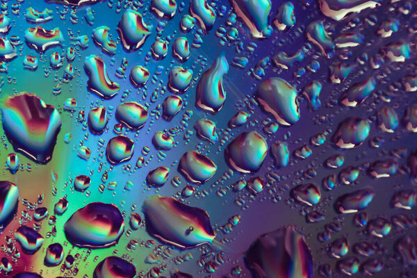 Beautiful abstract multi colored water drop of holographic effect. Background pattern for design. Macro photography view.