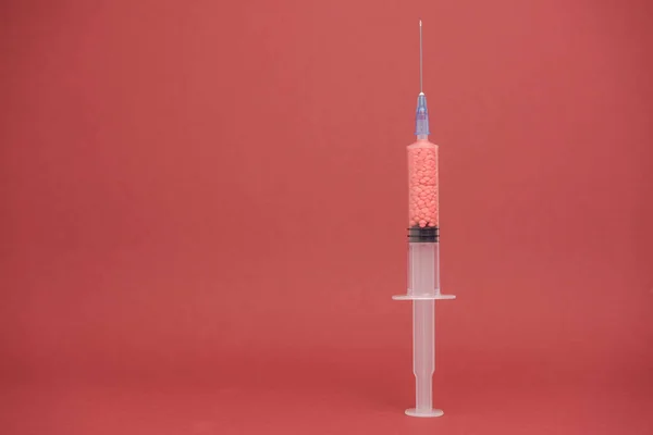 Beautiful syringe medical on a red background. Coronavirus concept, Protect yourself.