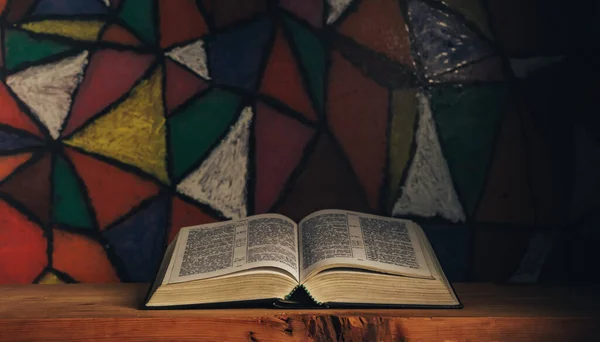 Die Bibel Auf Einem Roten Holztisch Aufschlagen Schöne Buntglasfenster Hintergrund — Stockfoto