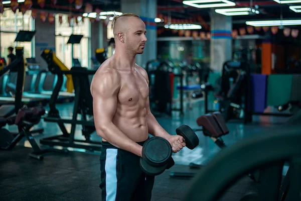 Avrupa yakışıklı yapar egzersiz pazı jimnastik salonu için dumbbells ile. Hong Kong Çin Asya'da kasları güçlü bir çekici sporcu ile seksi spor fotoğraf çekimleri