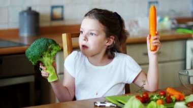 Brokoli ve havuç elinde tutan kız.