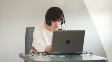 Orta yaşlı erkek müşteri kulaklık kullanmak tavsiye verir. Danışmanı destek hizmeti çalışır