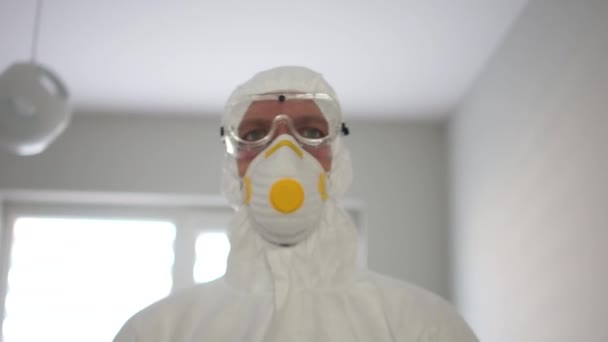 Protection contre le coronavirus, menace pandémique. Portrait rapproché d'un homme vêtu d'une combinaison isolante protectrice et d'un masque — Video