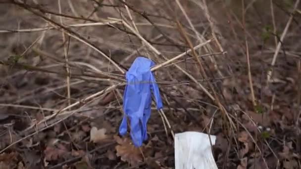 Coronovirus covid-19 und die Ökologie des Planeten. Medizinischer Müll liegt auf dem Boden in einem Park. Recycling medizinischer Masken und Handschuhe — Stockvideo