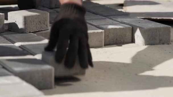 Close-up, Worker in gloves lays paving slabs — Stock Footage Close-up, Worker in gloves lays paving slabs Stock Footage
