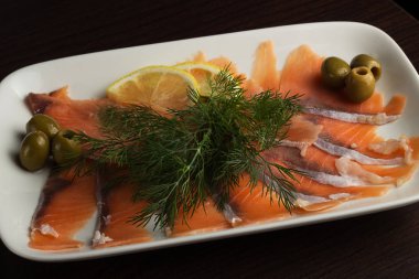 İki dilim alabalık filetosu baharatlar, limon ve biberiye beyaz arka plan üzerinde izole